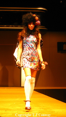 photograph of fashion model in white socks mini dress hat and accessories.